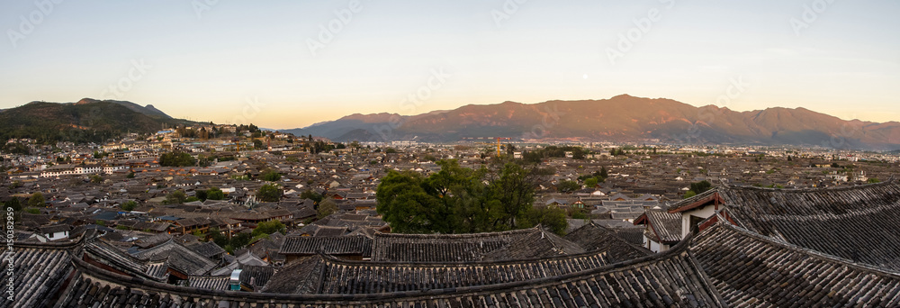 Evening bird eye view of local historical architecture roof building of Old Town of Lijiang in Yunnan, China.