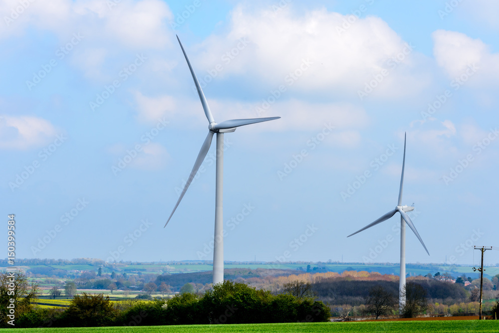 Wind Turbines and Blue Sky with Clouds over UK fields