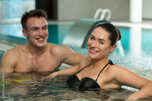 Beautiful loving couple relaxing in a jacuzzi tub together © Zoriana