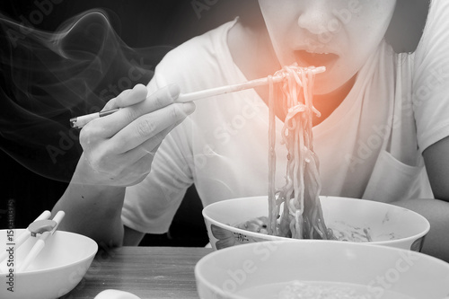 Asian women are eating hot noodles with spicy flavors.