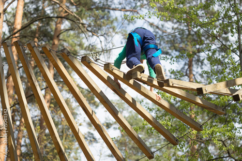 Gomel, Belarus - 30 April, 2017: Rope town for a family holiday in the countryside. Family competition to overcome aerial obstacles.