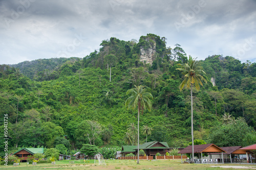 Village under calcareous mountain in Thailand