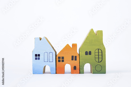 Colorful wooden miniature house on white background  real estate concept