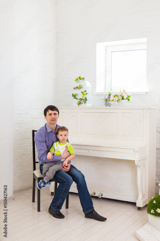 family, childhood, fatherhood, activity and people concept - happy father and little son playing at home family, childhood, fatherhood, activity and people concept - happy father and little son playing at home