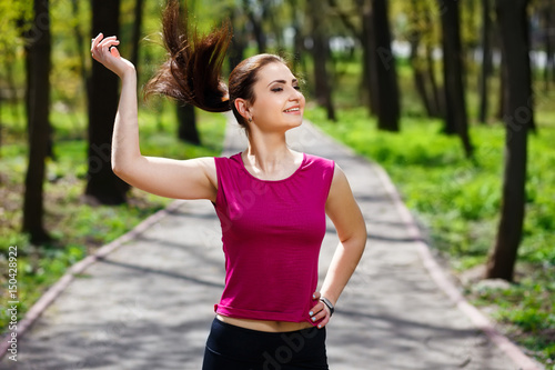 Young pretty fit woman jogging in the park.