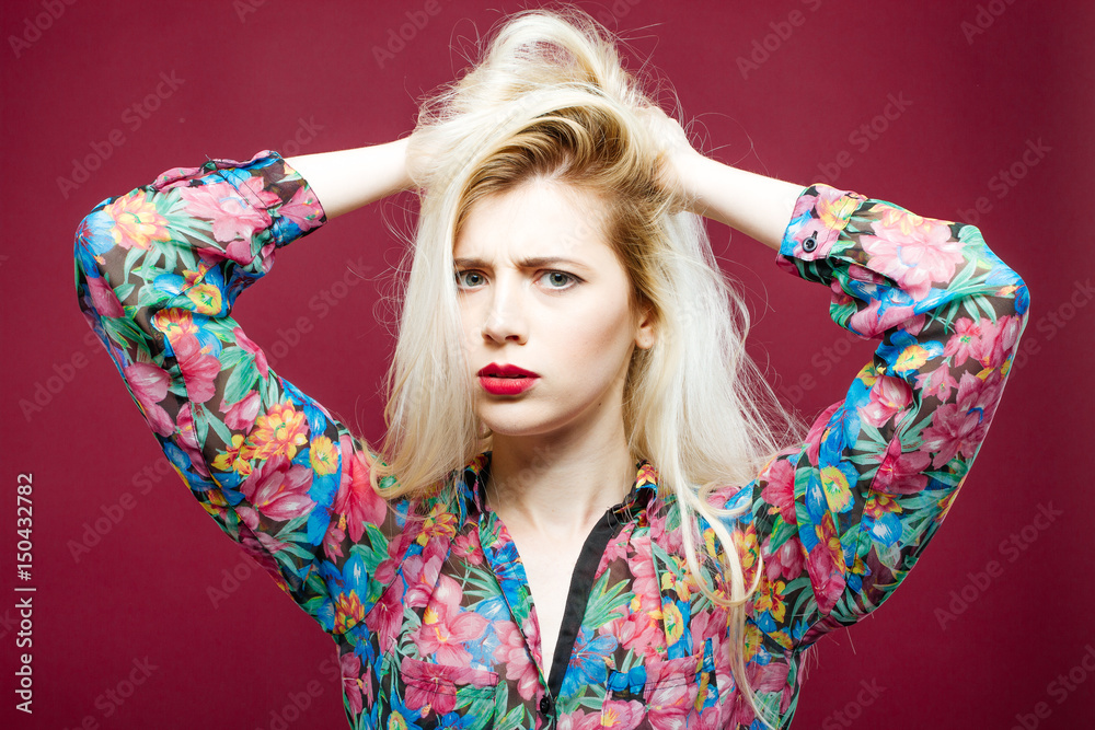 Sad Woman with Sensual Lips on Pink Background. Shocked Girl with Long Hair Wearing Colorful Shirt is Looking at the Camera in Studio. Sad Woman with Sensual Lips on Pink Background. Shocked Girl with Long Hair Wearing Colorful Shirt is Looking at the Camera in Studio.