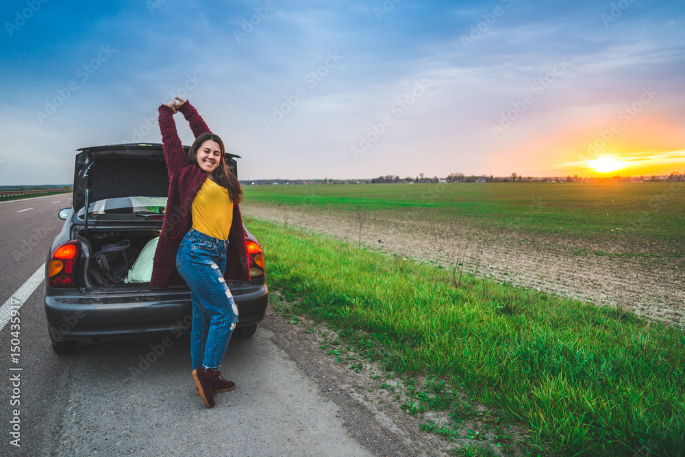woman stratching near car long car trip woman stratching near car long car trip