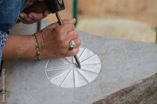 Close Up of Hand Working With Chisel and Hammer Carving in Stone