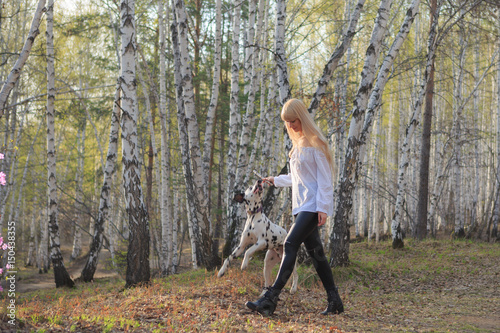 Beautiful woman and his dog posing outside