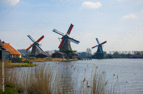 Old wooden windmills. Zaanse Schans river view. Netherlands