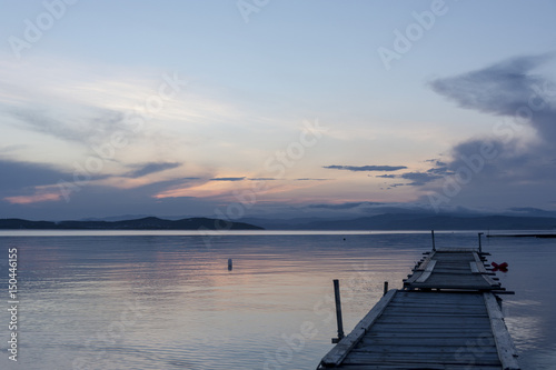 Wooden pontoon bridge in Greece, at sunset time