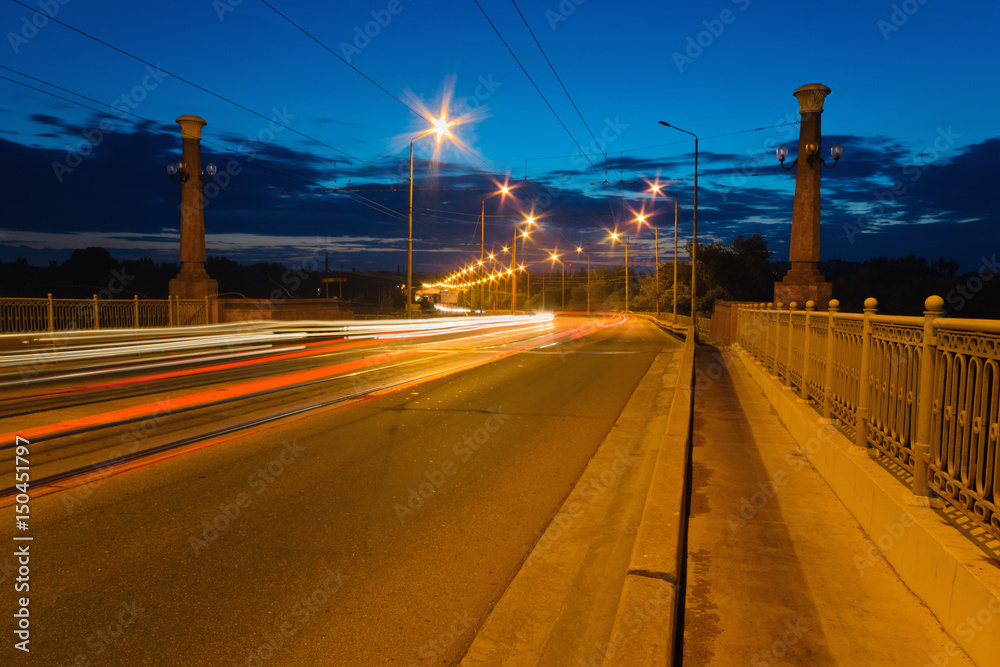 Tracers from passing cars on the bridge at dusk Tracers from passing cars on the bridge at dusk