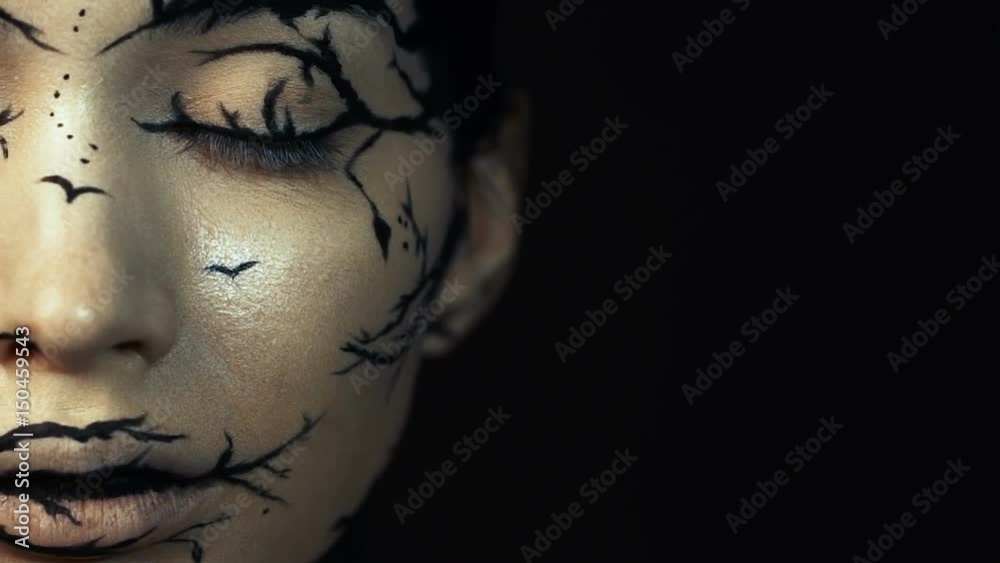 Fashion close-up slow motion portrait of model female with a amazing creative make-up.