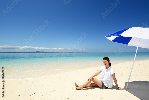 南国沖縄の美しいビーチで寛ぐ女性   © sunabesyou