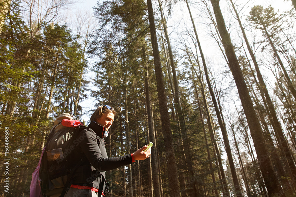 Disoriented hiker checking her phone for direction
