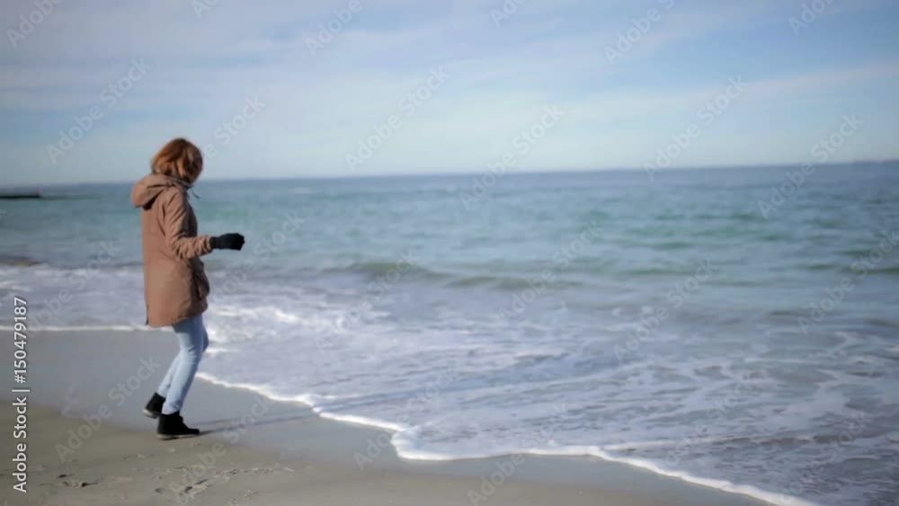 Beautiful woman walking  on a sunny beach in Odessa