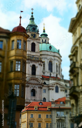 Fototapeta Naklejka Na Ścianę i Meble -  The Church of Saint Nicholas: a Late-Gothic and Baroque cathedral in the Old Town of Prague in Czech Republic. Tilt-shift effect applied.