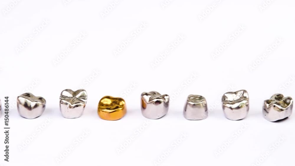 Dental gold and metal tooth crowns on white background. Isolated. Dental gold and metal tooth crowns on white background. Isolated.