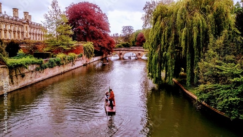 Sunday stroll in Cambridge overlooking River Cam . We are standing on the bridge watching the punting . 