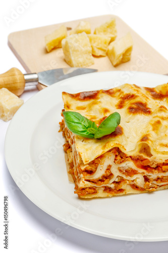Portion of tasty lasagna isolated on white