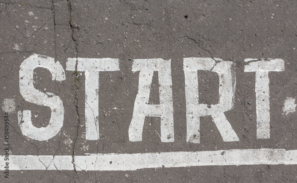 Start line painted on old asphalt, running track Start line painted on old asphalt, running track