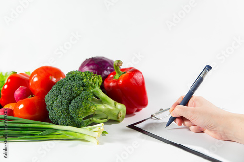 Nutritionist doctor writing vegetable diet plan