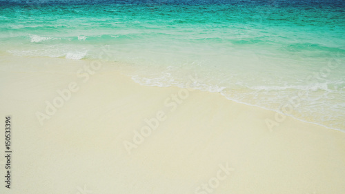 Soft wave of blue ocean on sandy beach