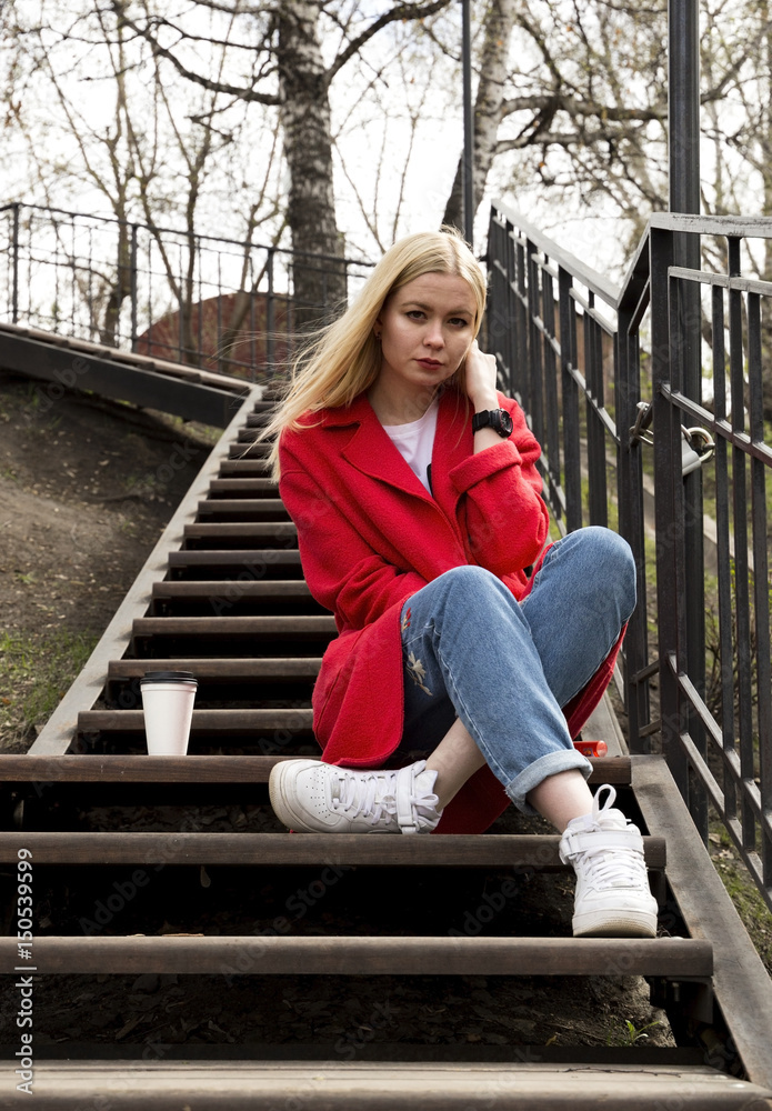 Beautiful girl in red coat drinks coffee to go (space for logo) Beautiful girl in red coat drinks coffee to go (space for logo)