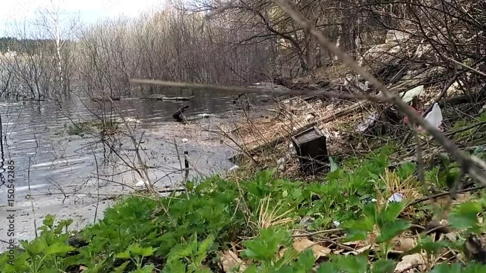 Garbage in the riverside shows the pollution. Garbage in the riverside shows the pollution.