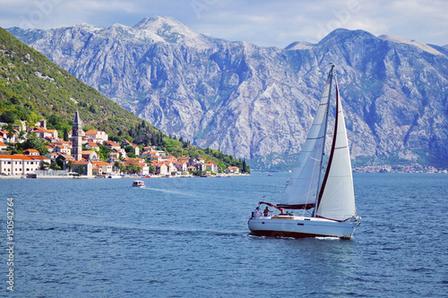 Sailing yacht on the background of Perast in Bay of Kotor (Boka Kotorska), Montenegro, Europe.