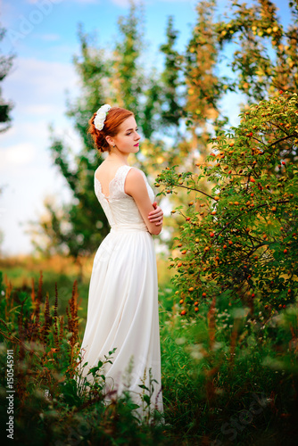 Wallpaper Mural Young beautiful blonde woman in blooming garden. Bride. Torontodigital.ca