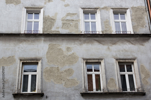 Six windows on the facade of the ragged old house