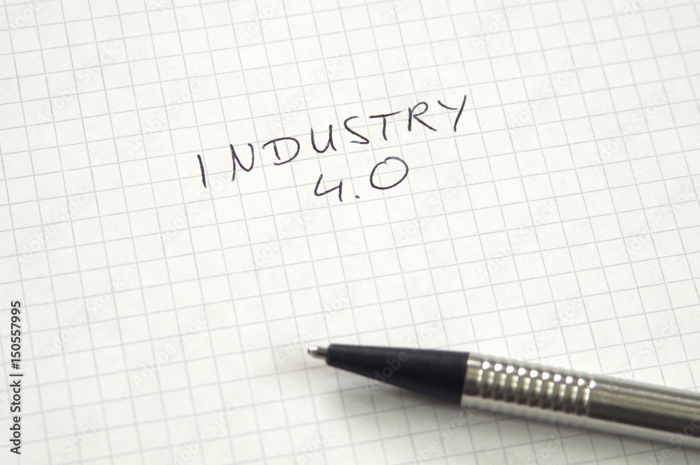 Industry 4.0 in handwriting on checkered paper with pen Industry 4.0 in handwriting on checkered paper with pen