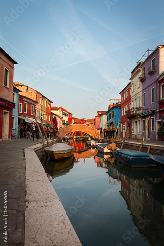 23 APRIL 2017, BURANO - ITALY. Beautiful Sunset with Boats, Buildings and Water. Sun Light. Toning. Burano, Italy.