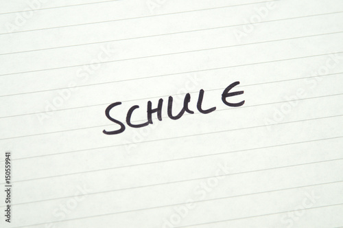 Word Schule  School  in Handwriting on lined paper