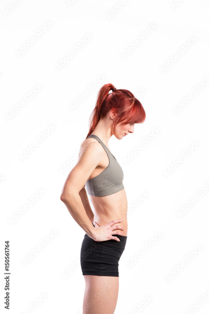 Attractive young fitness woman in sports bra. Studio shot. Attractive young fitness woman in sports bra. Studio shot.