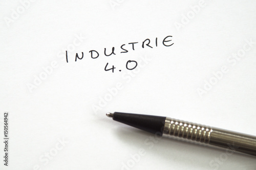 Industrie 4.0 (Industry 4.0) in handwriting on white background with pen