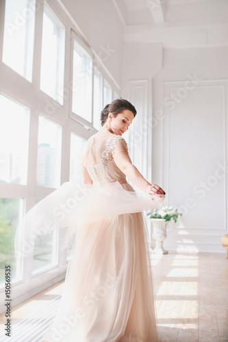 portrait of beautiful bride indoor. Fashion bride girl in gorgeous wedding dress in studio.
