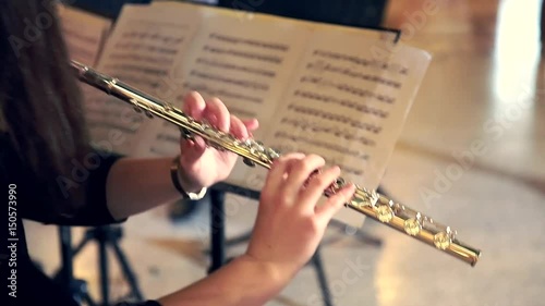 Woman Musician Plays the Flute. Flutist Professionally Playing the Flute in the Orchestra, Classic Music
