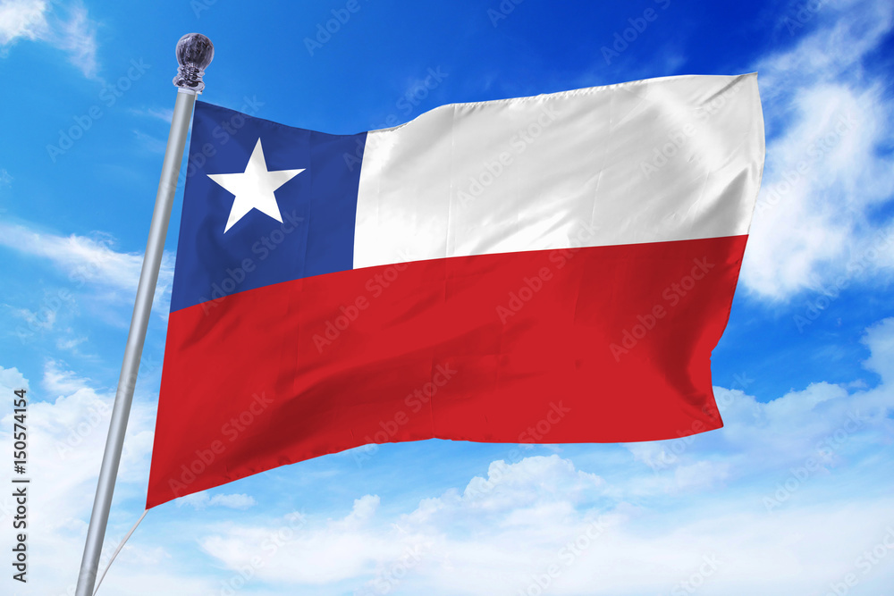 Flag of Chile developing against a clear blue sky Flag of Chile developing against a clear blue sky
