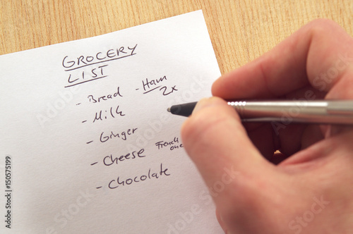 DSC00466_Handwritten_grocery_list_on_white_note_paper_hand_with_pen.jpg