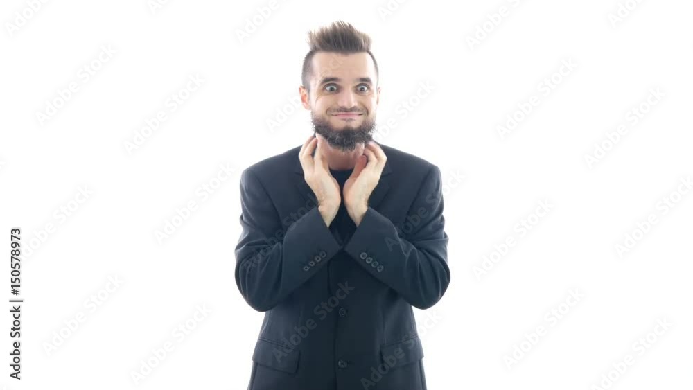 Funny bearded man in suit grimacing, touching his beard and looking at you, studio isolated on white background. Funny bearded man in suit grimacing, touching his beard and looking at you, studio isolated on white background.