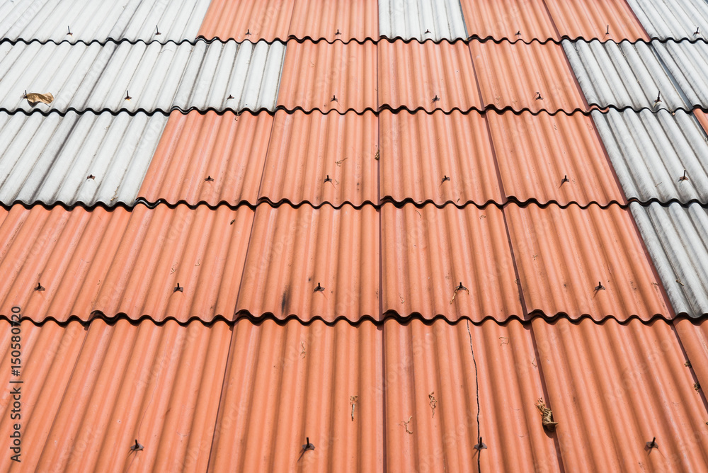 Orange roof tile and purple background texture. Top view of tile roof orange color. Orange roof tile and purple background texture. Top view of tile roof orange color.