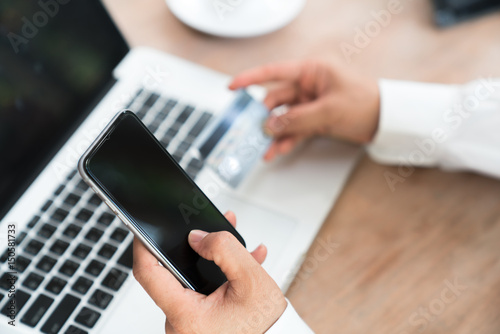Business man hand holding a credit card and phone