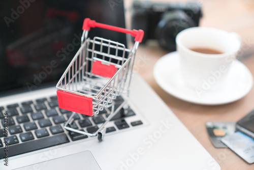 Online shopping website on laptop screen with shopping cart.