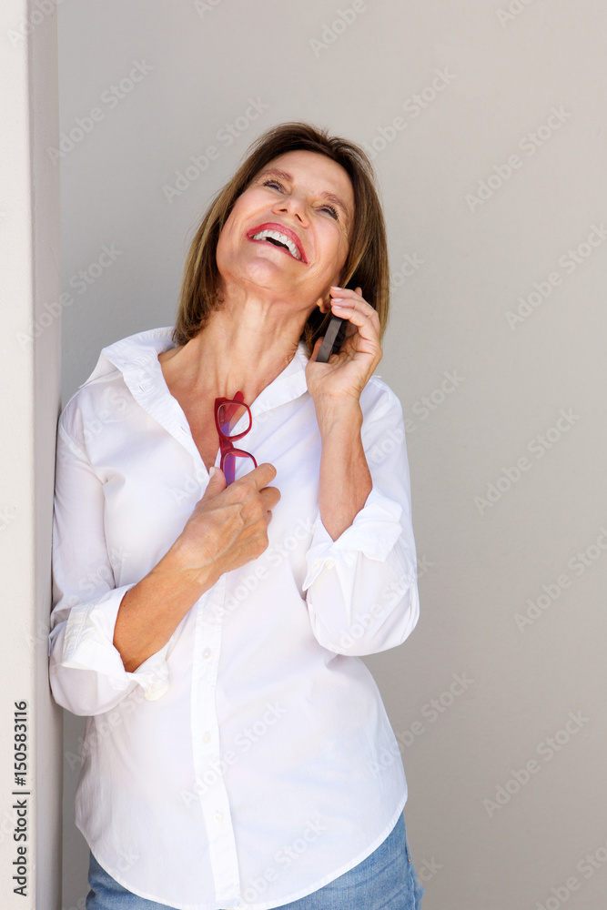 businesswoman talking on mobile phone and laughing businesswoman talking on mobile phone and laughing
