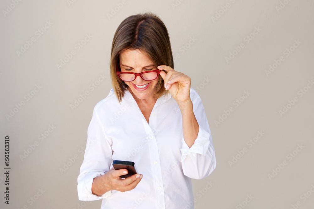 businesswoman with glasses looking at cellphone