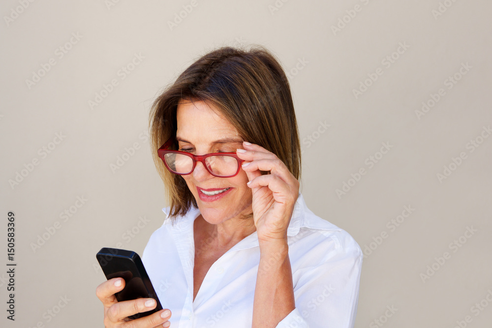 Close up businesswoman with glasses looking at cell phone
