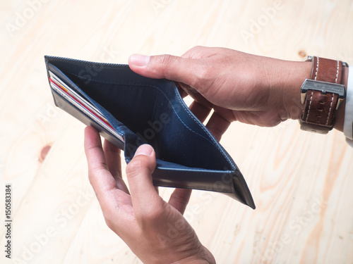 Bussinessman holding an empty wallet in his hands
