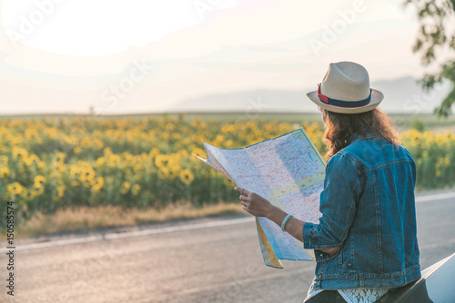 Women tourist with map and car looking for a way, tourist concept.